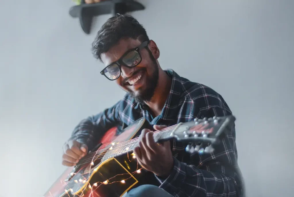 Person with guitar playing song.