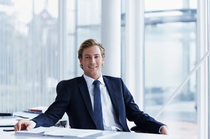 Handsome businessman sitting at desk