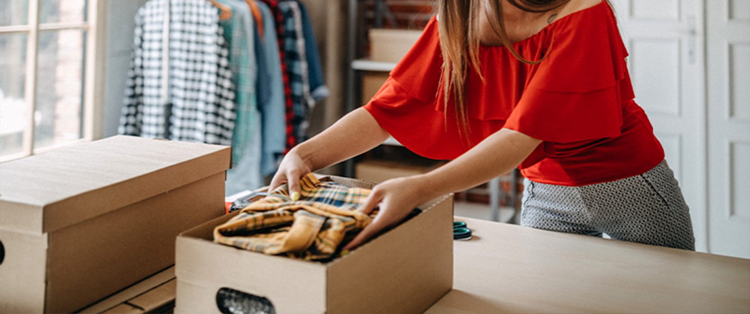 A small business owner packs products.