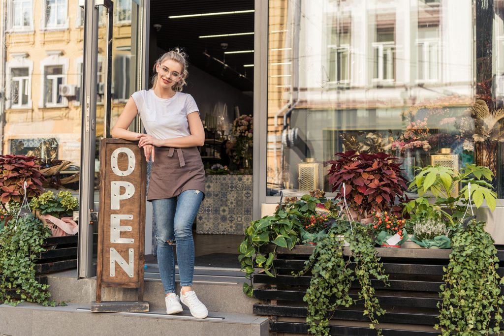 a business owner stands outside ready to sell their products.