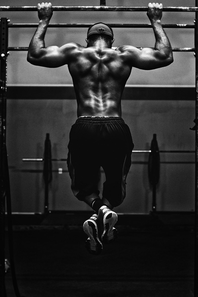 A fitness instructor does pull-ups.