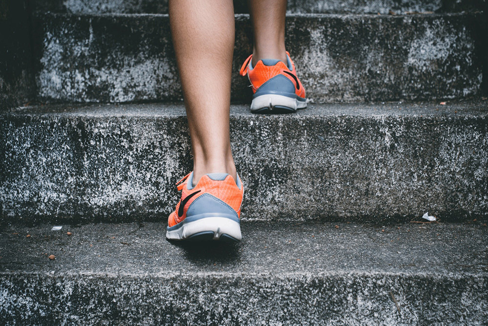 a trainer running up stairs.