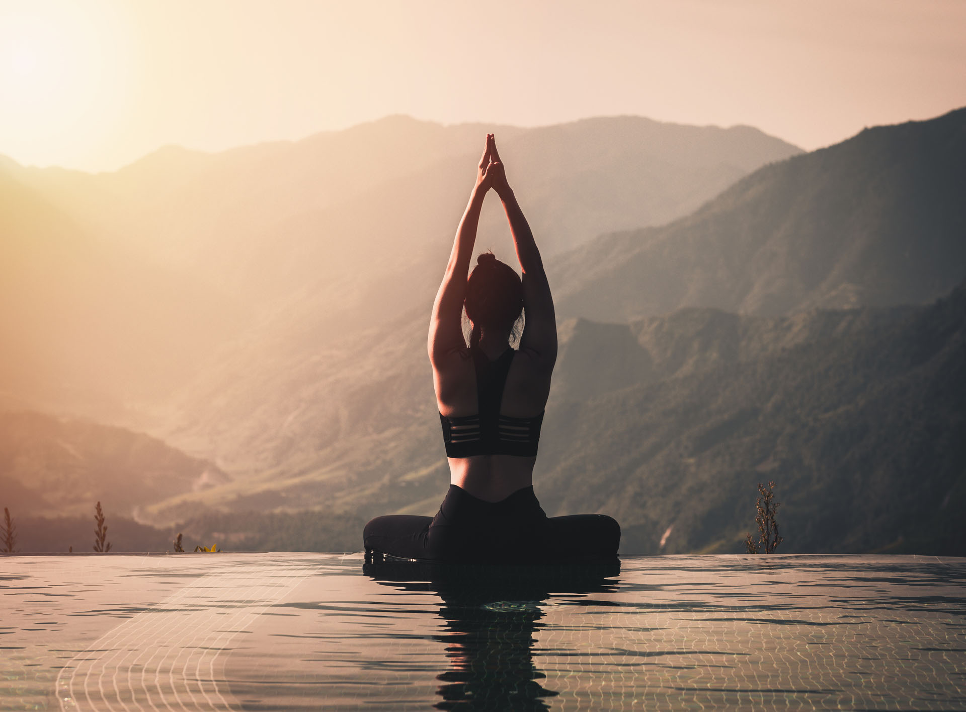 A yogi poses by the mountains.