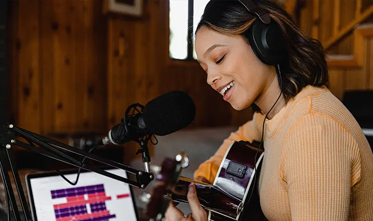 woman singing and playing guitar