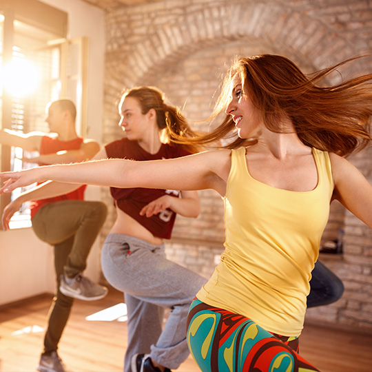 A Zumba class enjoys a workout together.