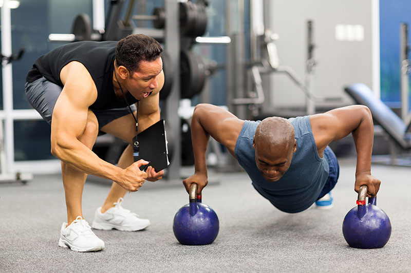 A sports trainer helps condition an athlete.