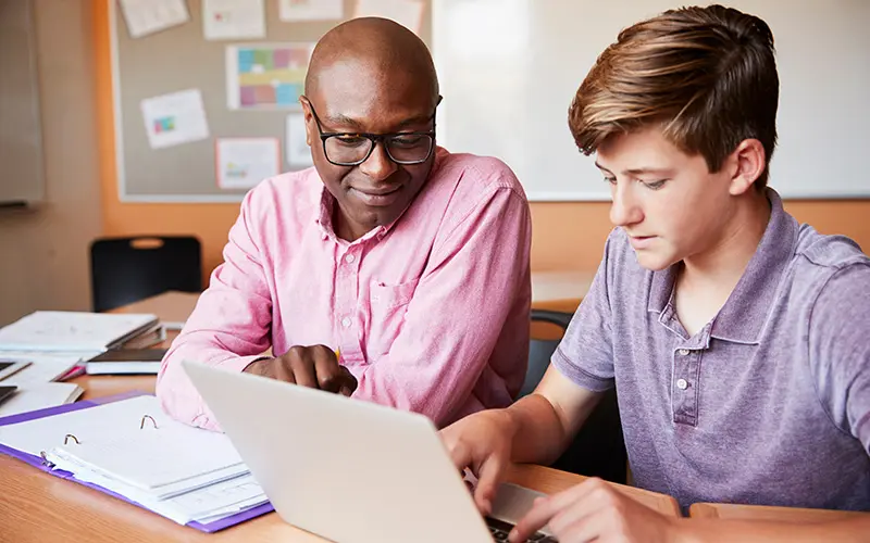 An insured tutor helps a student prepare for the ACT.