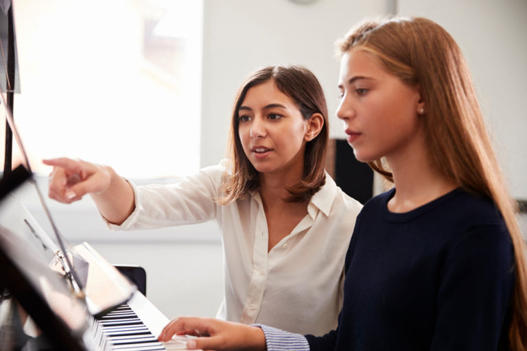 private piano teacher with student