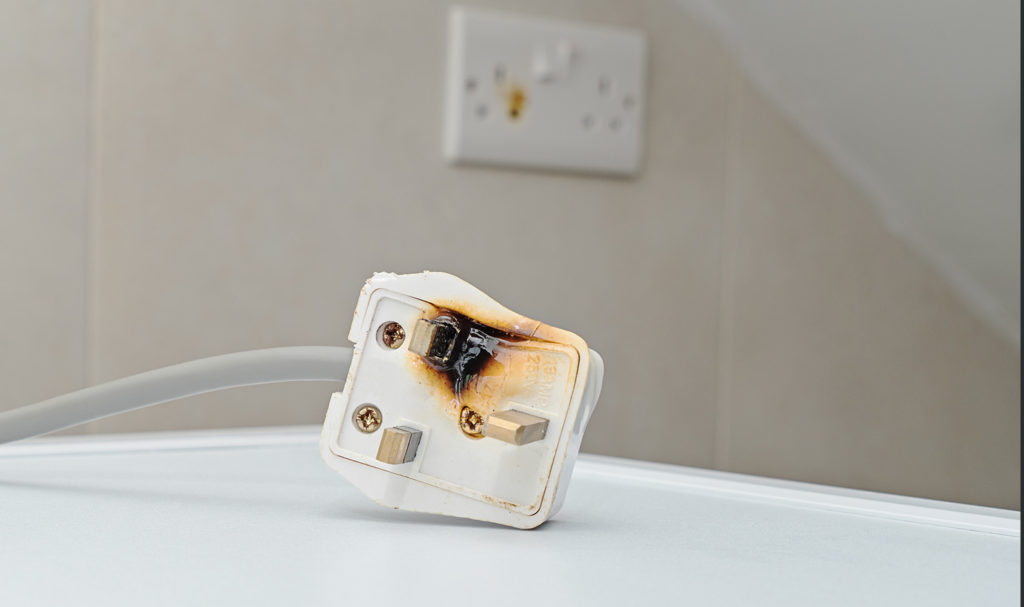 A burnt plug shows the dangers and risks electrical components contain and why it is important to have product liability insurance.