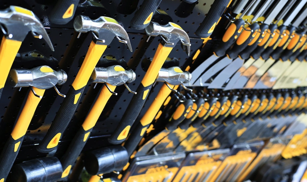 A wall of hammers at a store are on display and are insured with product liability insurance.