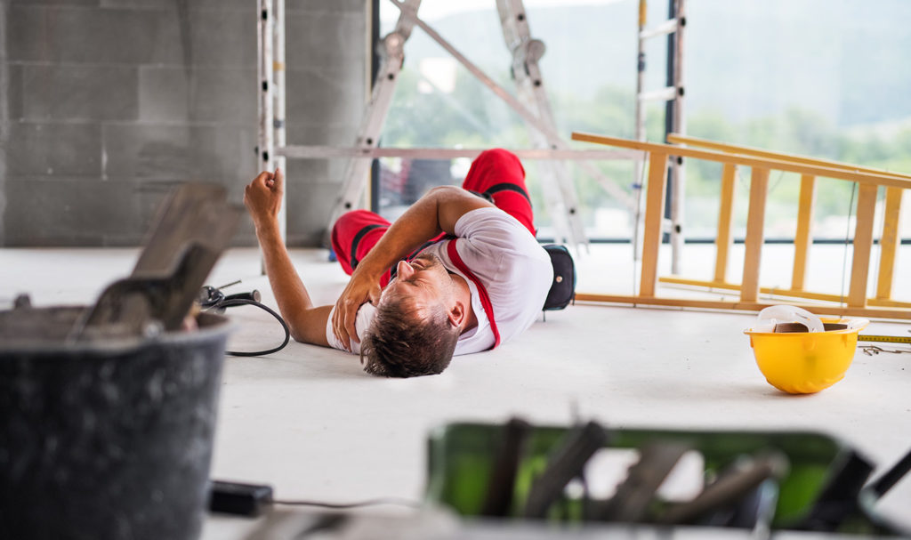 A man is laying on the ground in pain in a construction site after falling off of a ladder he bought years prior. With occurrence-based product liability insurance policy, this incident would not be covered and the injured person could still sue the ladder manufacturer.