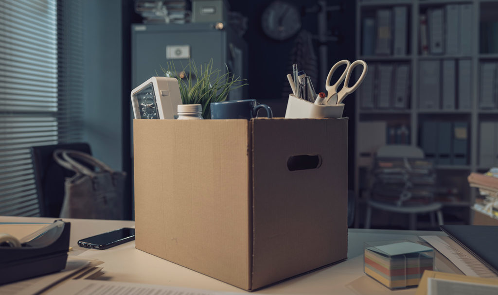A box of old office items sits in a box on a desk. With the right policies, these items could still be covered by product liability insurance.