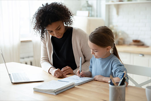 female tutor helping young student