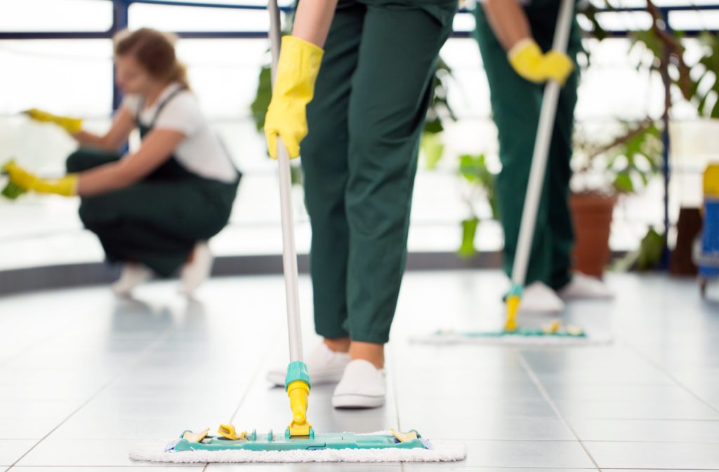 close up of mop with cleaning crew