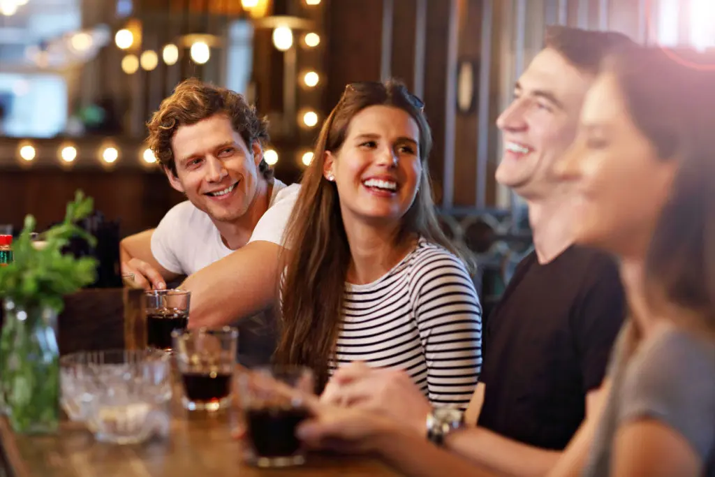 Group of people enjoying drinks at restaurant
