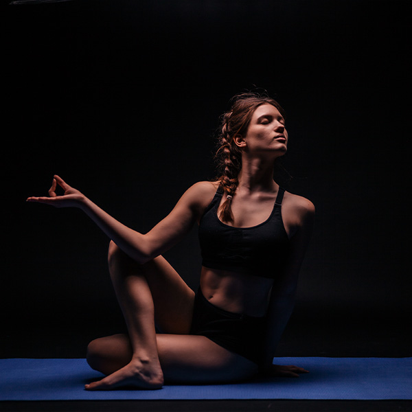 A yoga teacher practices yoga in a studio.