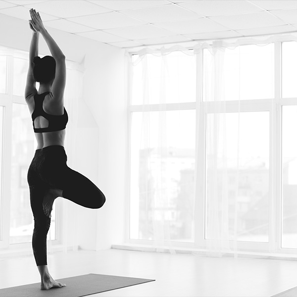 A yoga instructor practices indoors.