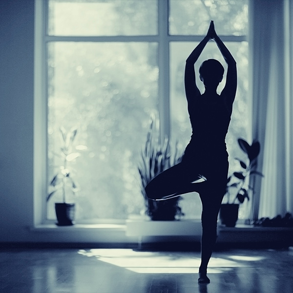 A yogi in front of a window.