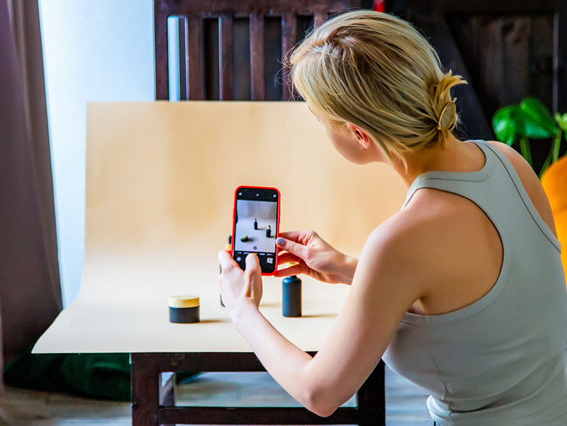 A business owner takes photos of their products.