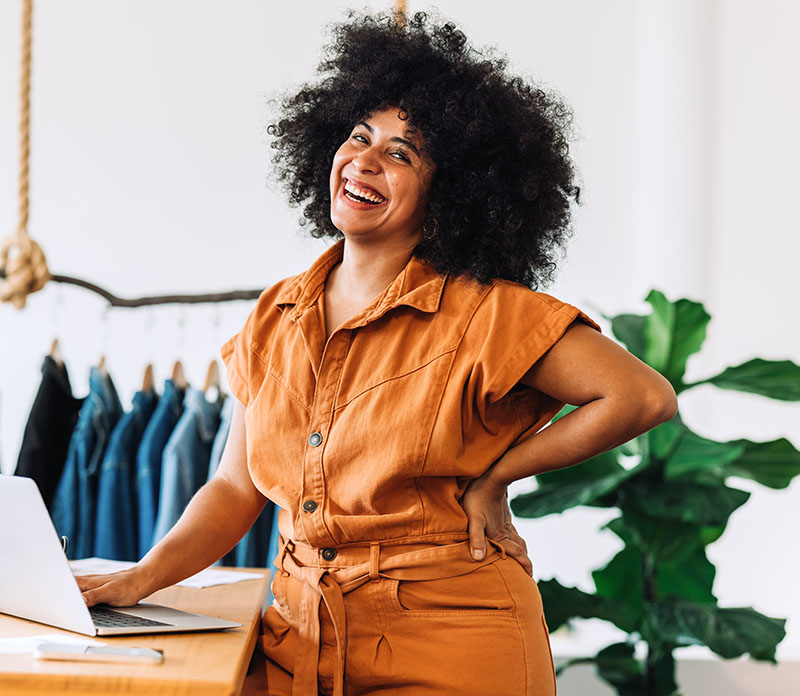 A business owner smiles in her store.