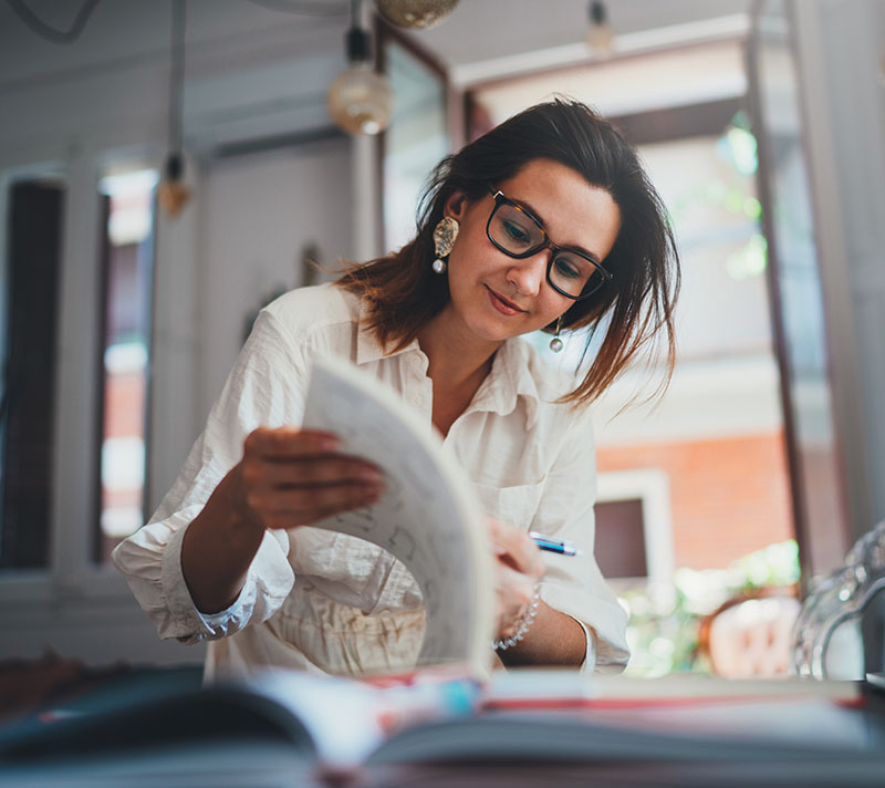 A business owners looks through paperwork.