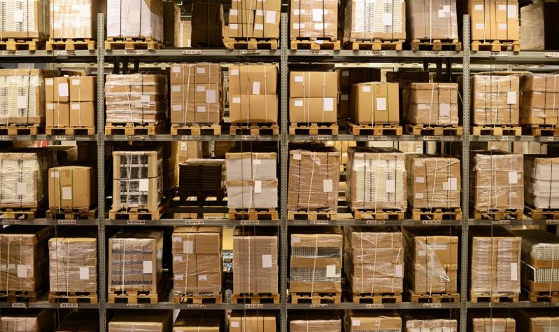 A floor to ceiling shelf in a warehouse full of boxes of products. Wholesaler product liability insurance can help insure these types of items wholesalers manage.