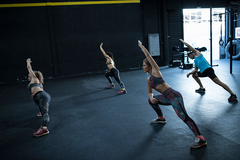 A fitness class stretches together.