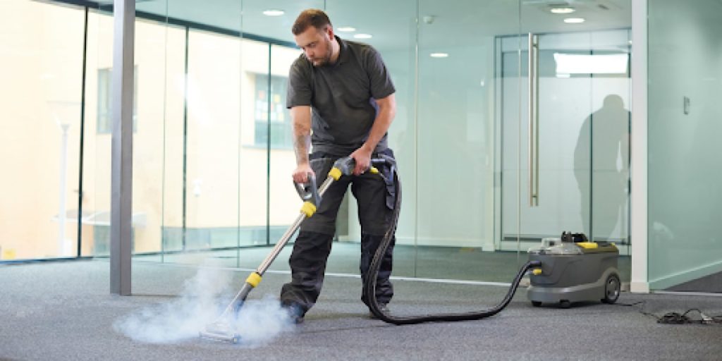 A cleaner working on a carpet.