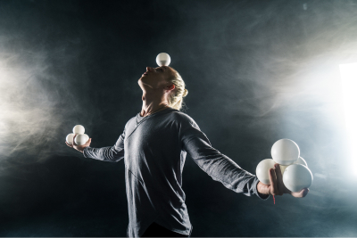 man balancing juggling balls