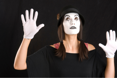 female mime with hands up