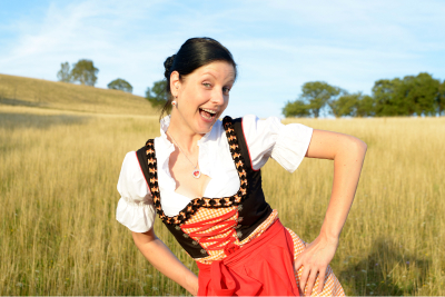 woman in german clothes yodeling in a field