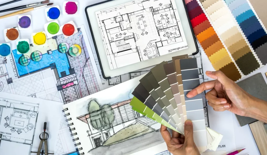 Various color swatches, fabric swatches scattered around house design plans.