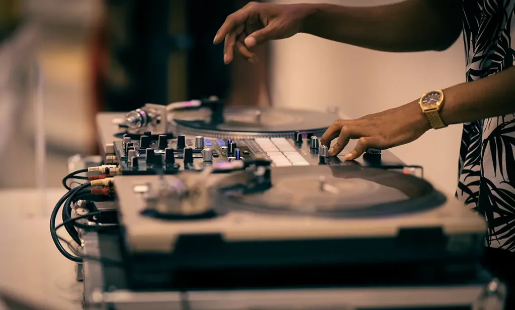 DJ using turntable and mixer