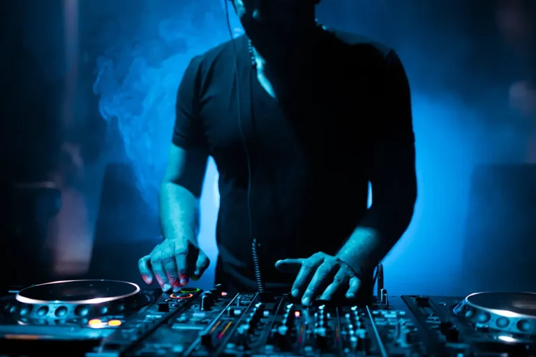 DJ at event with dark lighting