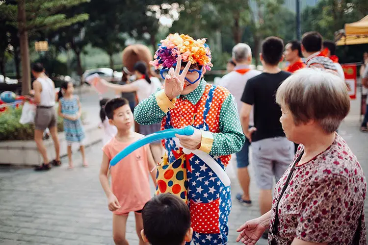 Colorful Clown at fair with balloons