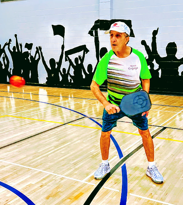 Ram playing pickleball on an indoor court.