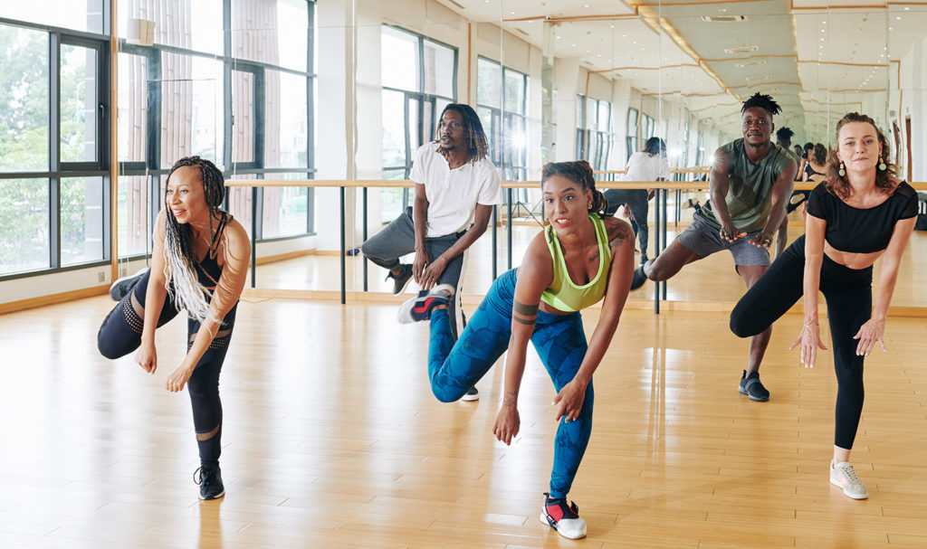 A group of dancers learning a new routine together.