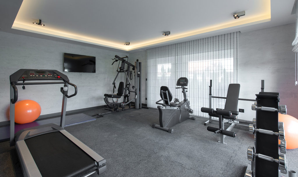 An at-home gym filled with various workout gear and equipment.