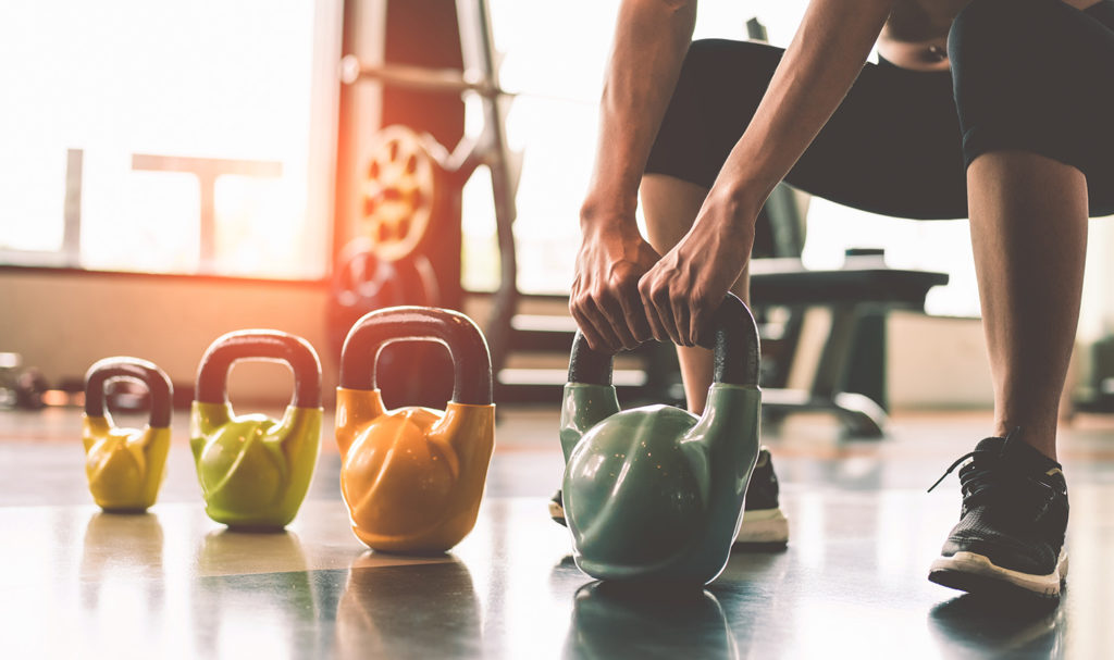 A fitness instructor is testing out their weights.