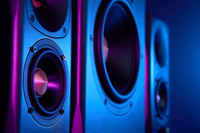 Close up look at DJ equipment speaker with blue and purple reflective lights