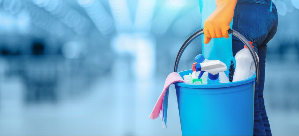 close up of someone holding a cleaning bucket by their side