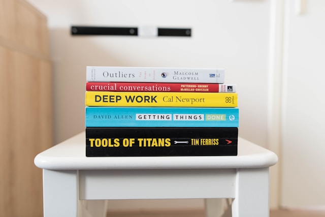 A stack of books with self-help titles