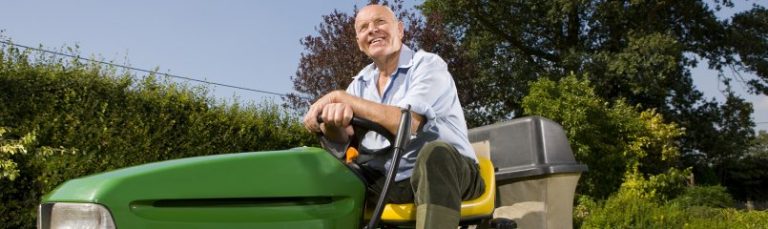 man sitting on riding lawn mower