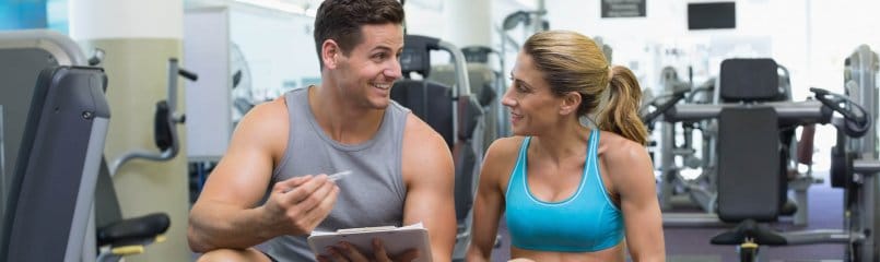Personal trainer explaining something to client