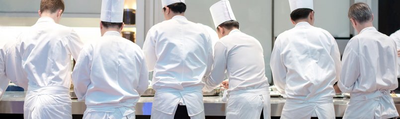 cooks preparing meals at a restaurant