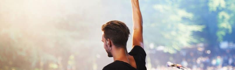 entertainer raising arm on stage