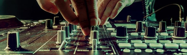 DJ adjusting knobs on sound board
