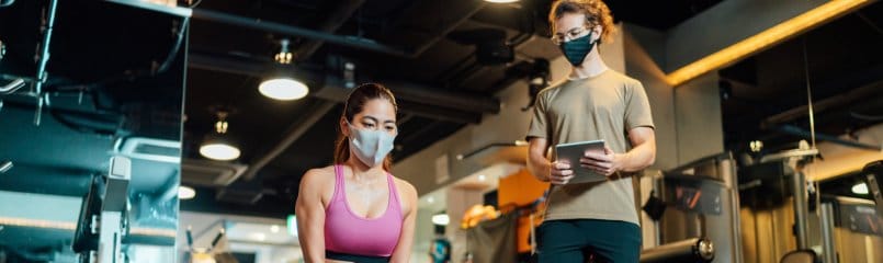 personal trainer and client social distancing in gym