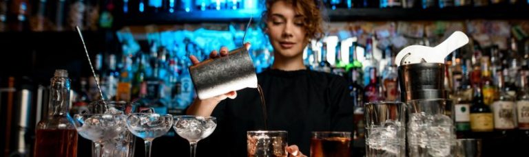 Woman bartender pouring drinks