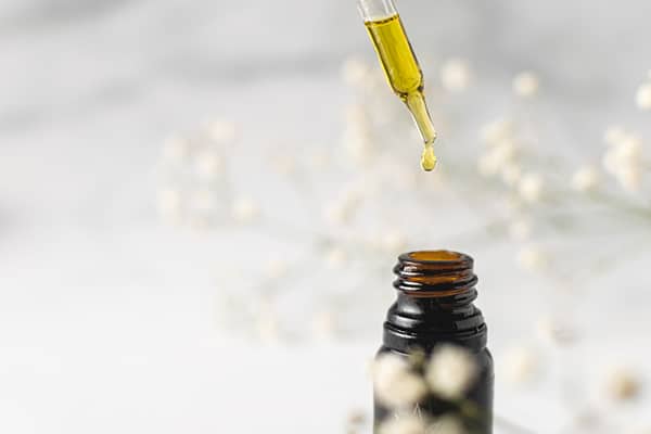 Cannabis Insurance keeps this topical CBD oil insured. It sits on a white table, ready for use.